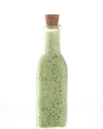 Cilantro Lime Vinaigrette - My PCOS Kitchen - Cilantro dressing in a glass bottle.