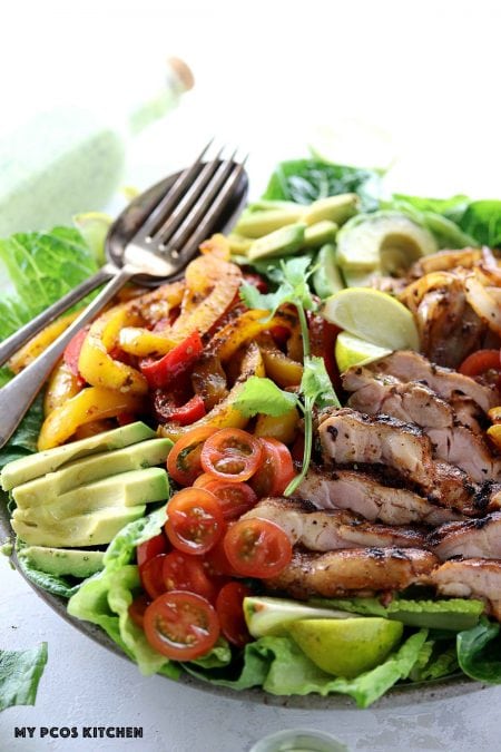 Keto Low Carb Chicken Fajita Salad - My PCOS Kitchen -  Grilled fajita chicken over a bed of lettuce, taco peppers and onions.