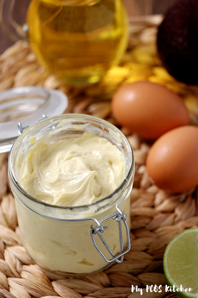 A glass jar full of homemade keto mayonnaise made in an immersion blender.