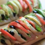 My PCOS Kitchen - Hasselback Chicken Caprese - A chicken breast sliced and stuffed with fresh mozzarella, pesto, tomatoes, basil and olives. Keto/low carb