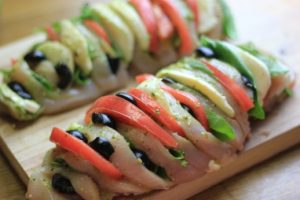 My PCOS Kitchen - Hasselback Chicken Caprese - A chicken breast sliced and stuffed with fresh mozzarella, pesto, tomatoes, basil and olives. Keto/low carb