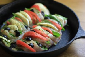 My PCOS Kitchen - Hasselback Chicken Caprese - A chicken breast sliced and stuffed with fresh mozzarella, pesto, tomatoes, basil and olives. Keto/low carb