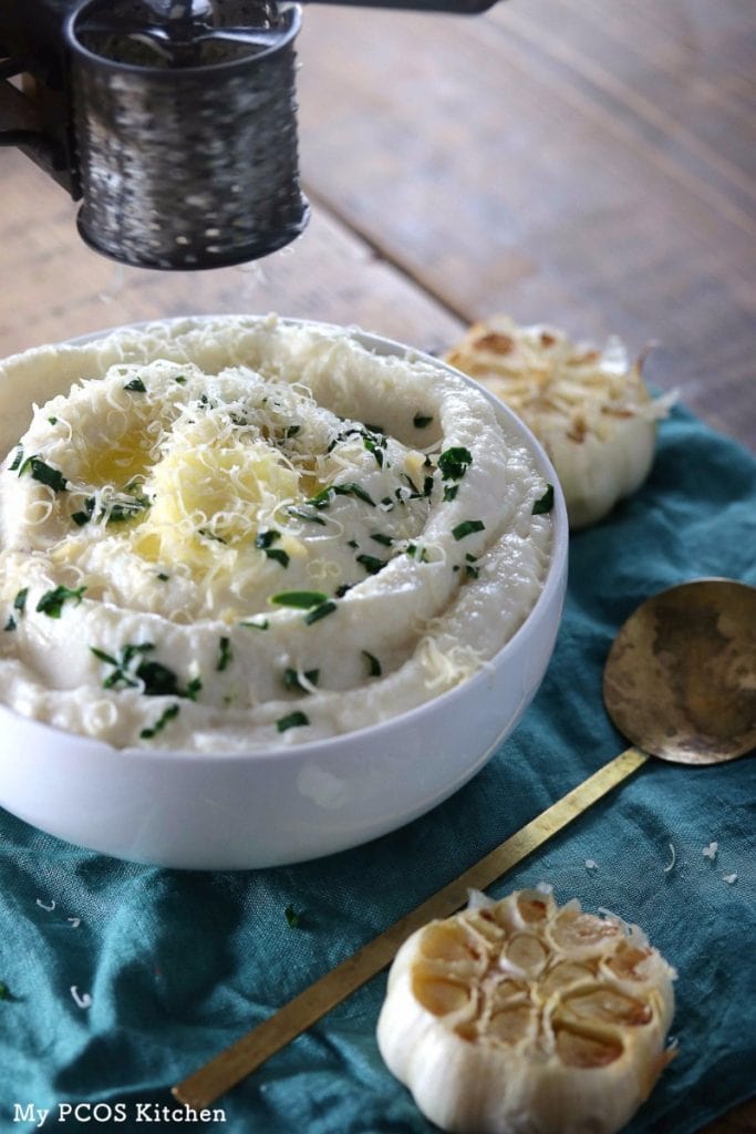 My PCOS Kitchen - Creamy Keto Mashed Cauliflower - This mashed fauxtato is so creamy, buttery and filled with roasted garlic! You won't even miss potatoes with this!