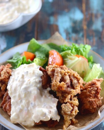 My PCOS Kitchen - Keto Paleo Fried Chicken - Gluten-free, Dairy-free, Grain-free, Pork-Free, Nut-free Fried Chicken - Delicious fried chicken over a blue ceramic plate and covered with dairy-free tartar sauce.