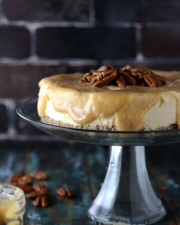 Sugar Free Low Carb Caramel Cheesecake - My PCOS Kitchen - An upfront shot of a cheesecake with caramel sauce drizzling from the sides.
