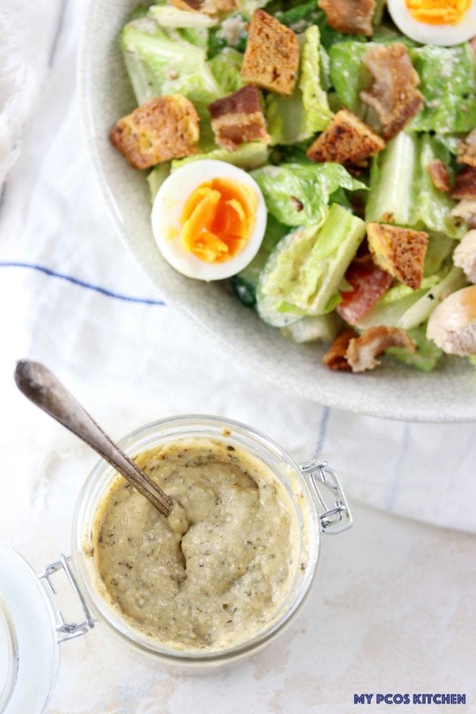 My PCOS Kitchen - Low Carb Homemade Caesar Salad Dressing - Large caesar salad with a batch of homemade sugar-free caesar dressing.