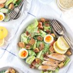 Low Carb Caesar Salad with Chicken - My PCOS Kitchen - An overhead shot of a chicken caesar salad with bacon, gluten free croutons and eggs.