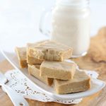 Low Carb Sugar Free Maple Fudge - My PCOS Kitchen - Creamy fudge over a small plate and a glass of almond milk in the background.