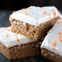 Sugar Free Carrot Cake - My PCOS Kitchen - Square carrot cake bars piled on top of another with some sugar free cream cheese frosting.