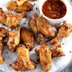 Sweet Chili Thai Chicken Wings - My PCOS Kitchen - Spicy thai chicken wings on a metal tray and a dipping sauce.