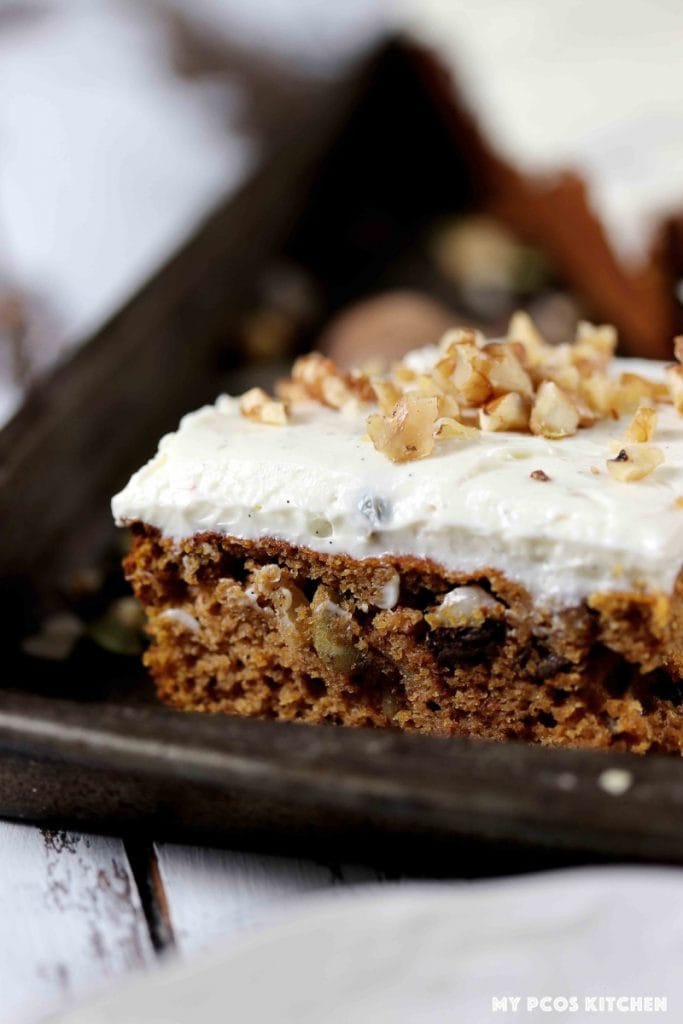 A closeup of a gluten free pumpkin bar topped with cream cheese frosting.