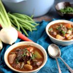 Two bowls of gluten free beef stew filled with hearty vegetables.
