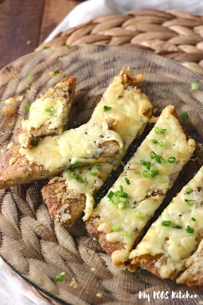 Slices of keto cheesy garlic bread with some green onions on top.
